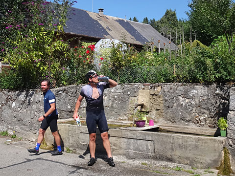 泉の水を被るサイクリスト